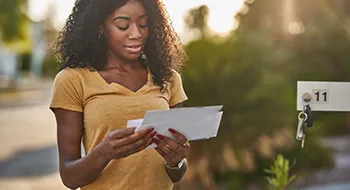 woman opening her credit card offer