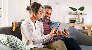 man and woman discussing looking at the computer